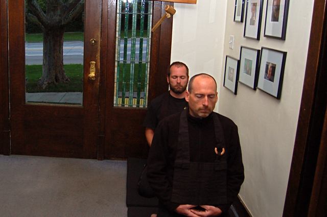two men standing in the doorway of an apartment