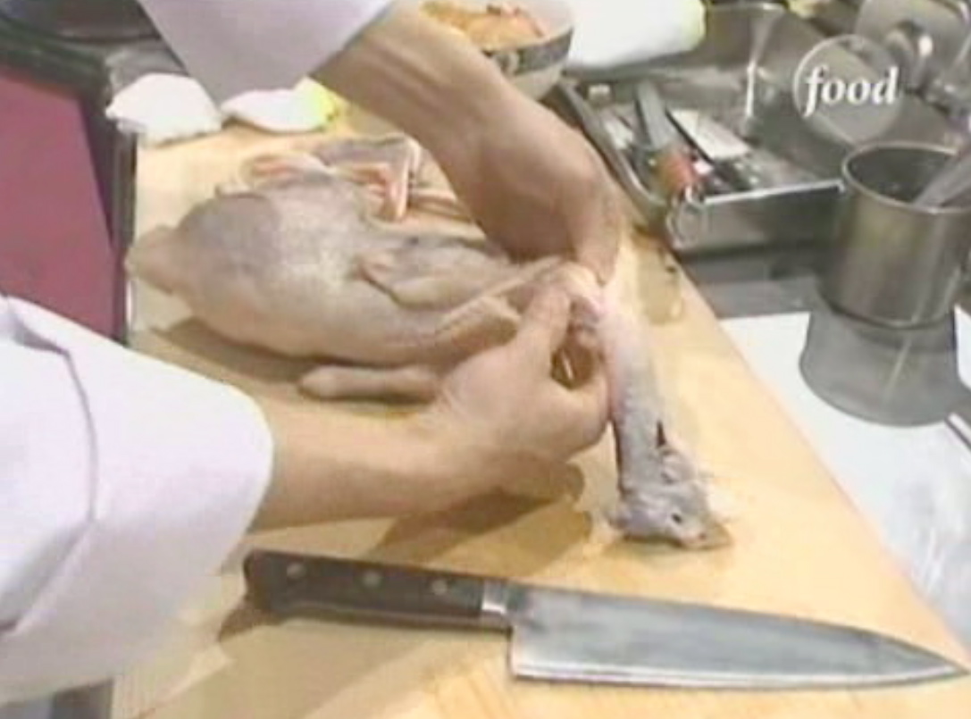 a chef peeling the skin off of a fish