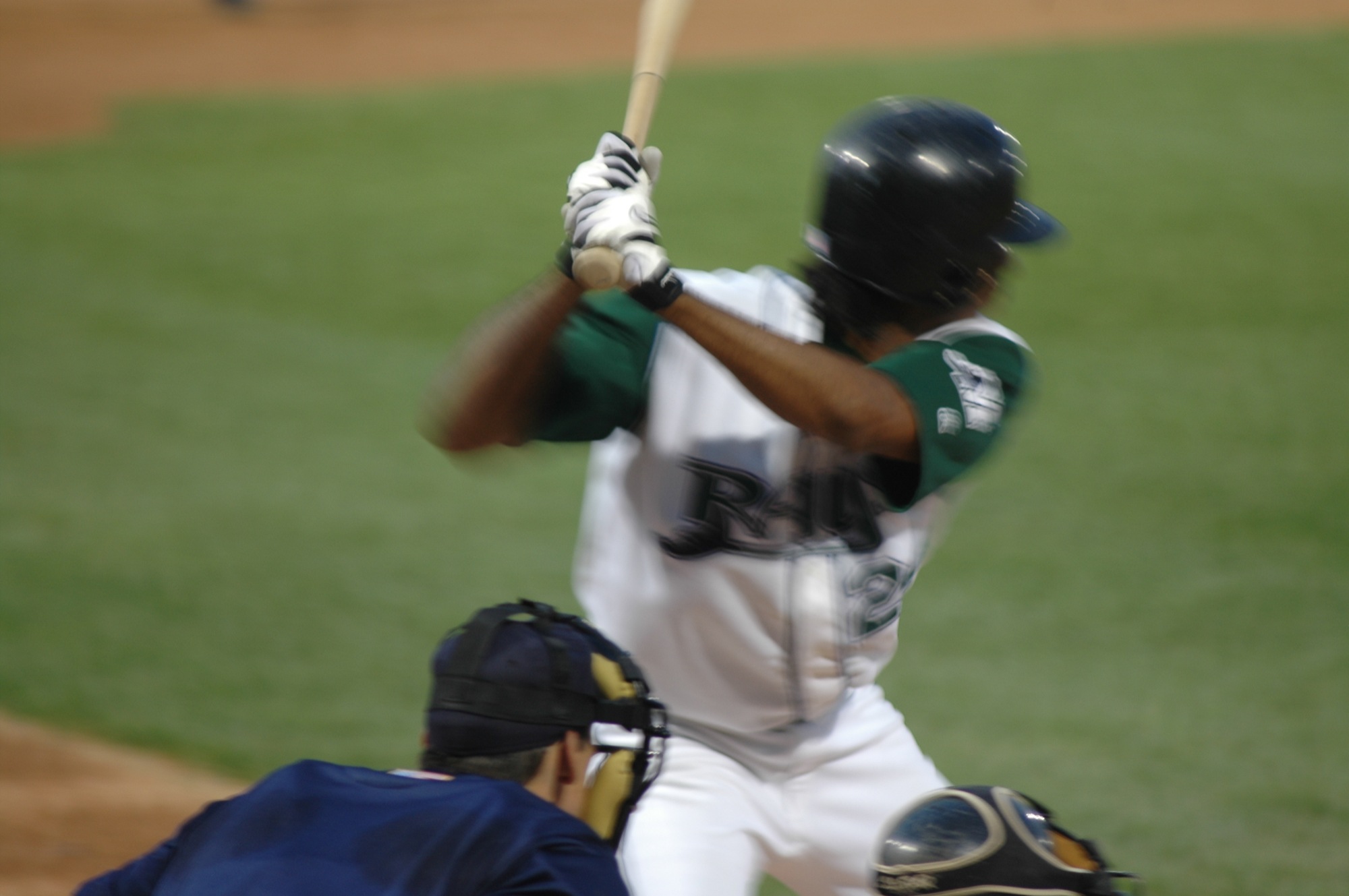 a baseball player holding a bat and wearing a helmet