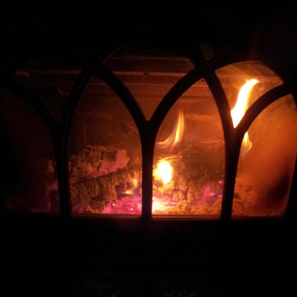 a glowing fire is lit inside of the oven