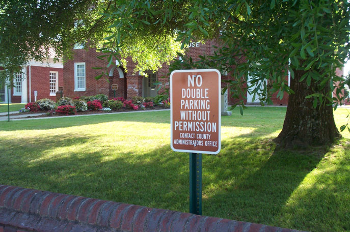 no drinking sign near brick sidewalk in front of house
