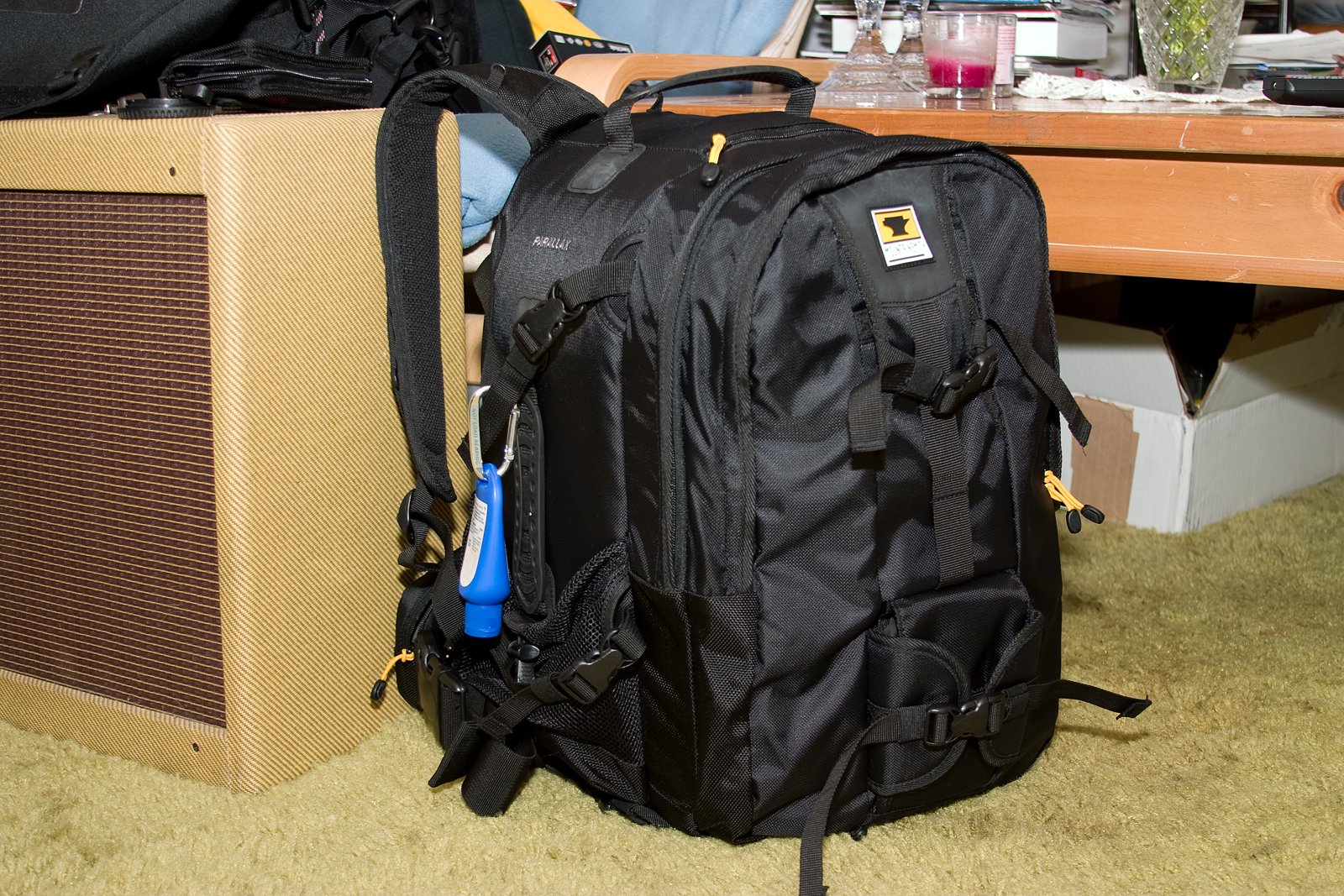 a backpack sits beside an amp with guitar parts attached