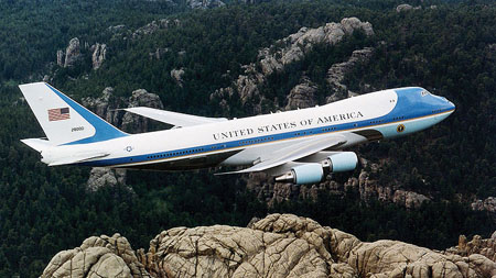 an airplane flies low over some rocks