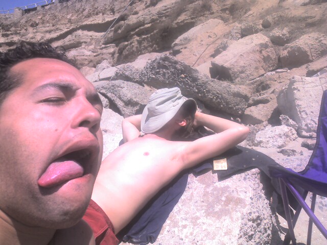 a man is lying on the rocks with his tongue sticking out