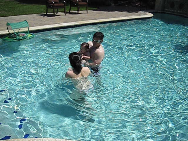 several people in a swimming pool near one another