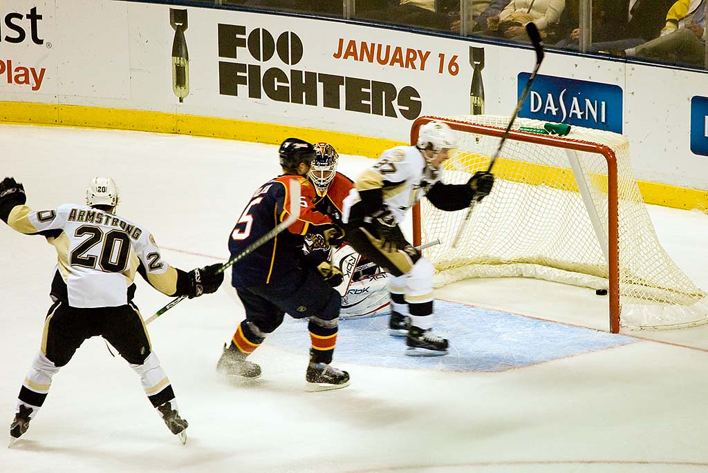 two professional hockey players are playing during a game