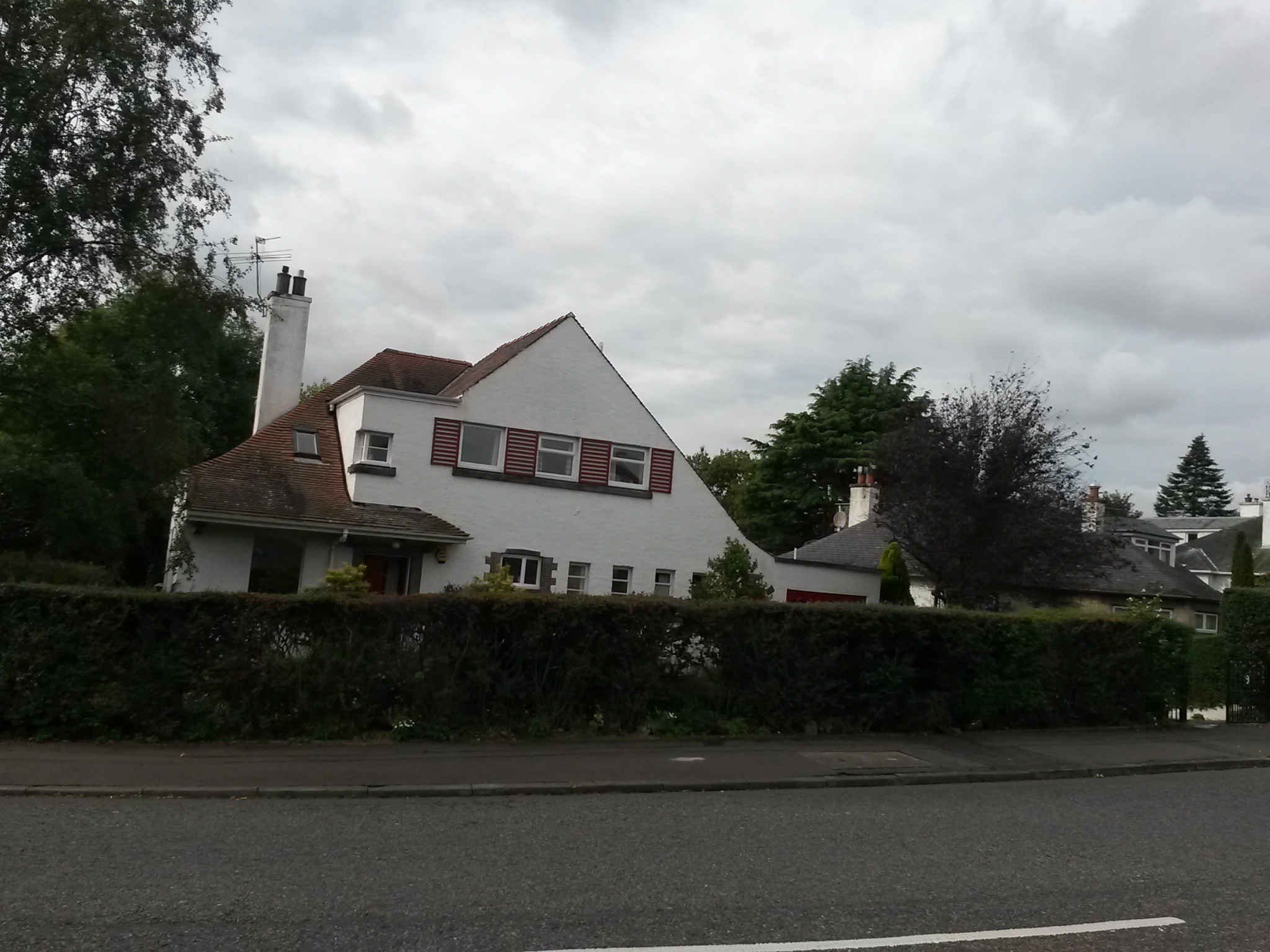 house with hedges and a sky background
