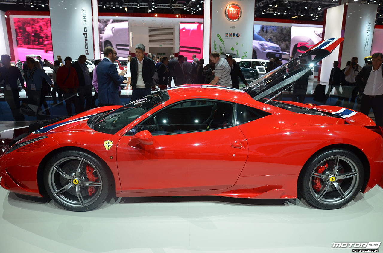 a red sports car on display at an auto show