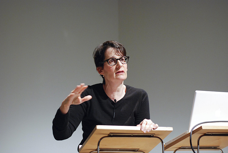 a woman is giving a presentation at an auditorium