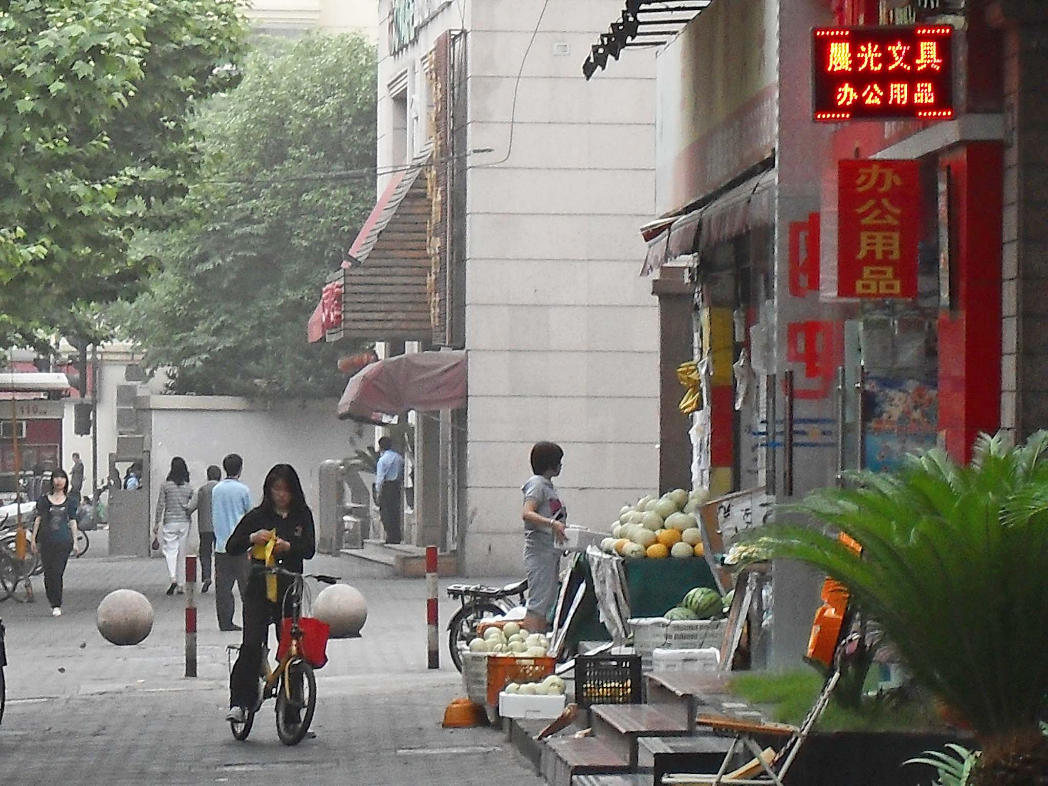 several people and bicycles in the street in an asian city