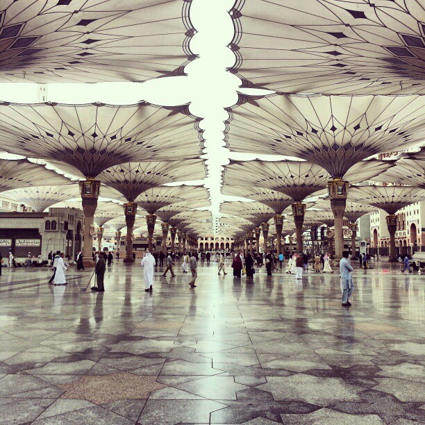 a big building with many open umbrellas overhead