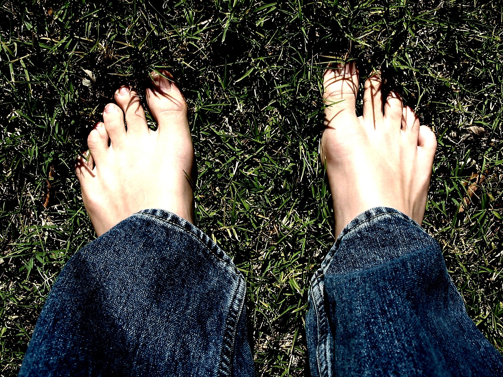 the legs and feet of a person in black jeans