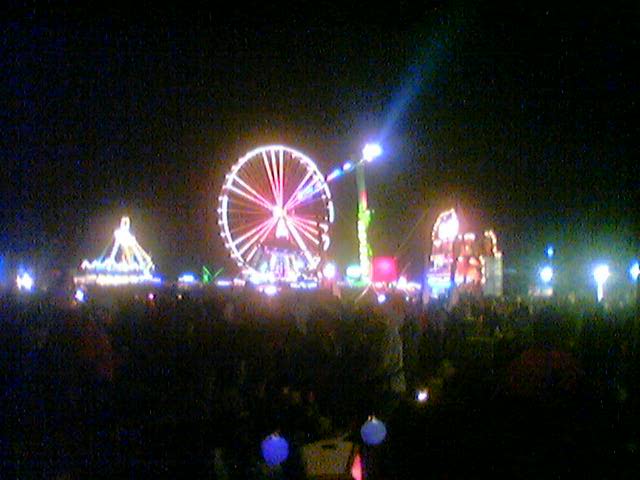 large ferris wheel lit up in the night sky