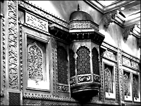 the ornate, stained and carved walls and ceiling of a mosque