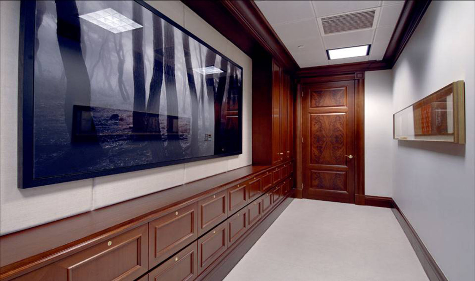 an empty hallway with a painting hanging on the wall