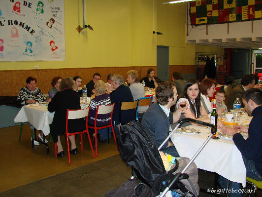 a group of people sitting around tables at a restaurant