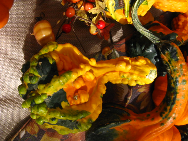 a small pumpkin statue sits on top of other decorations