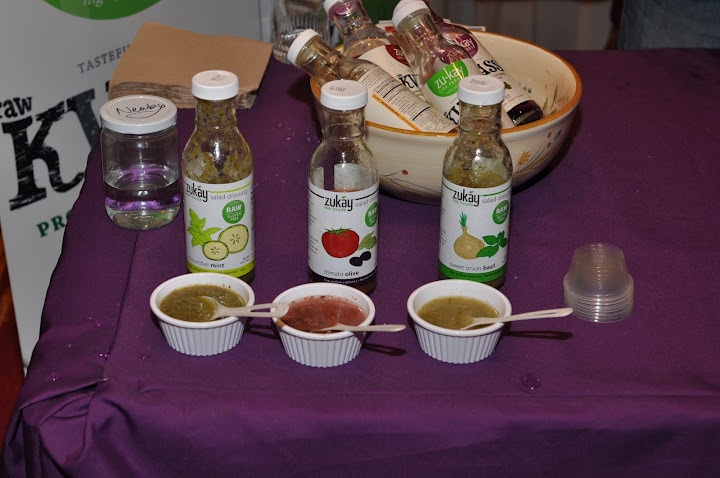 several bowls on a purple table with liquid bottles and utensils