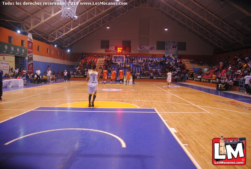 a basketball player in white jersey on court with spectators