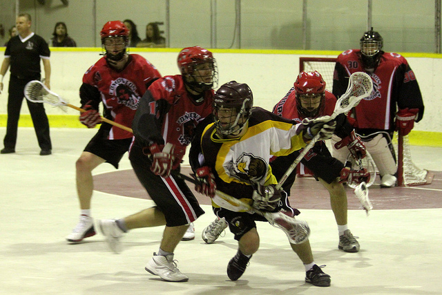 a group of young people playing a game of ice hockey