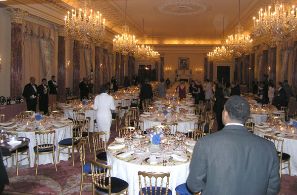 a room filled with tables and people in fancy settings