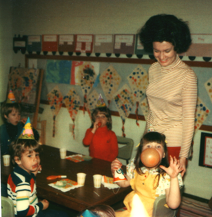 there are children gathered around a woman standing