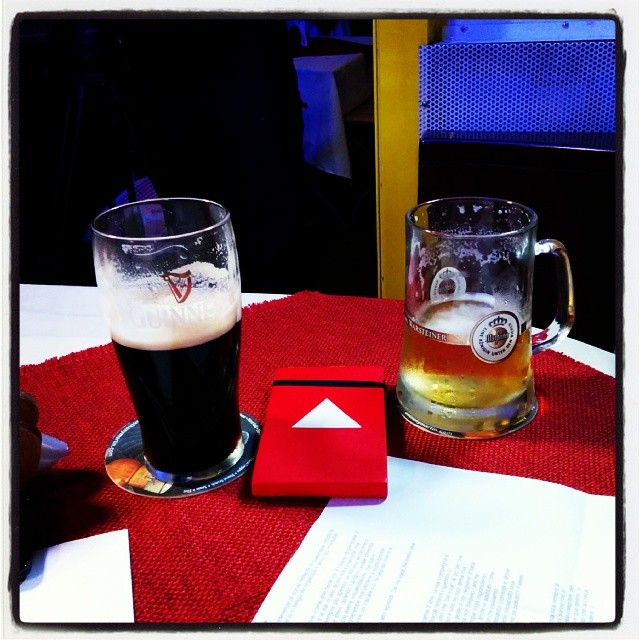 a red and white table cloth and beer glasses and book