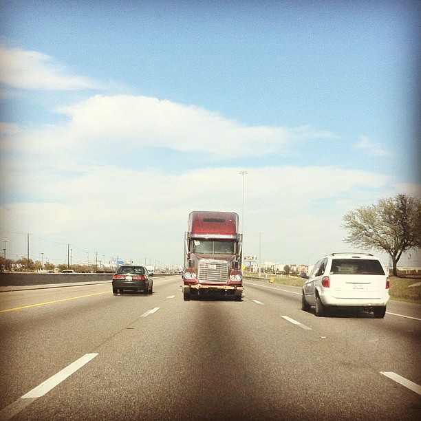 the view from the side of an suv on a freeway with traffic