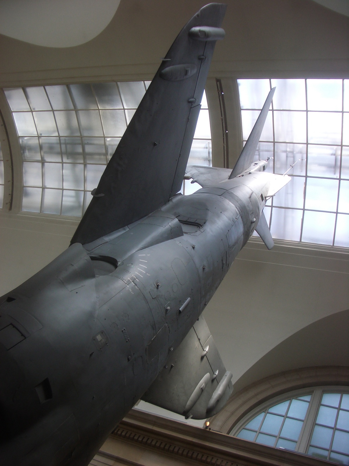 an airplane sitting inside of a large white and beige building