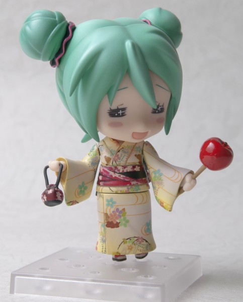 a toy that has a green hair and an umbrella