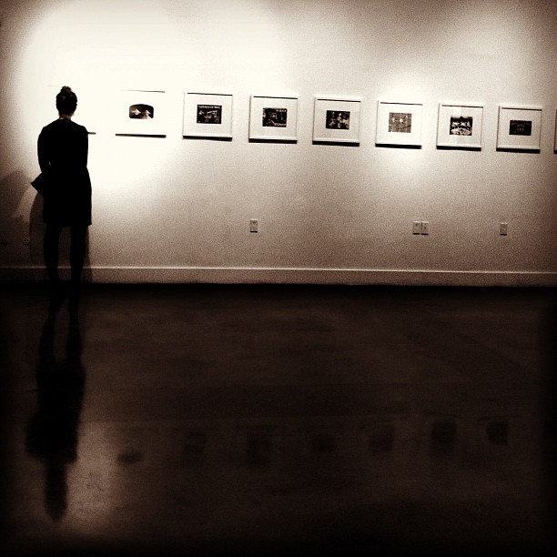 a person looking at an artwork in a room