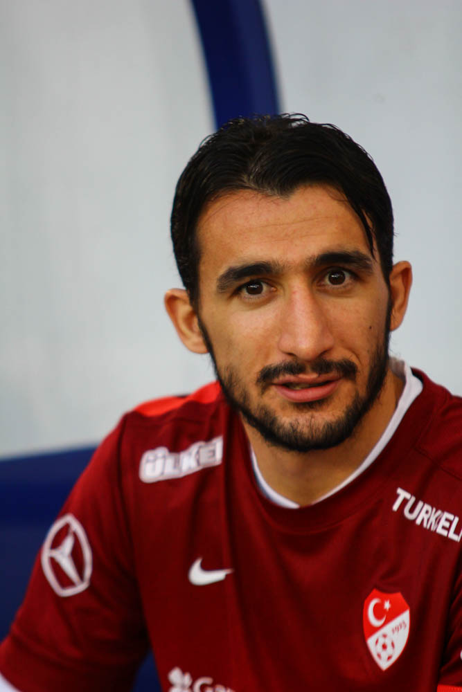 a man who is wearing a soccer uniform looking at the camera