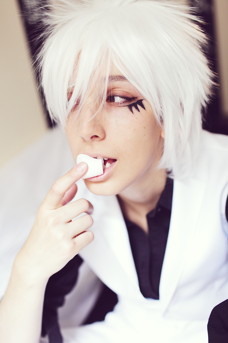 a person with white hair brushing their teeth