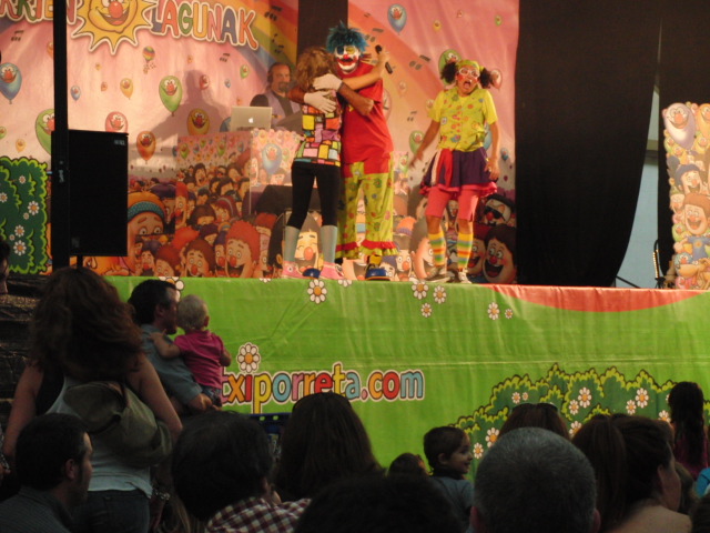 two clowns on a stage with children in the audience