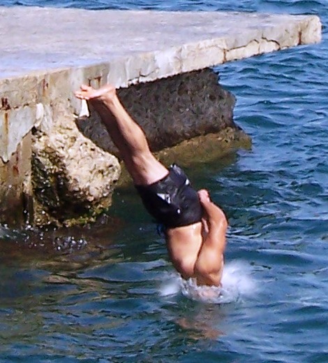 a man standing in water with his arms above his head