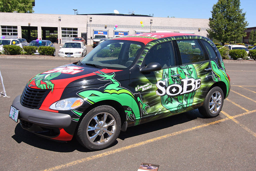 an automobile with an advertit painted on it in a parking space