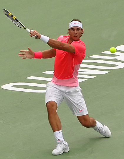 a tennis player swinging a racket at a tennis ball