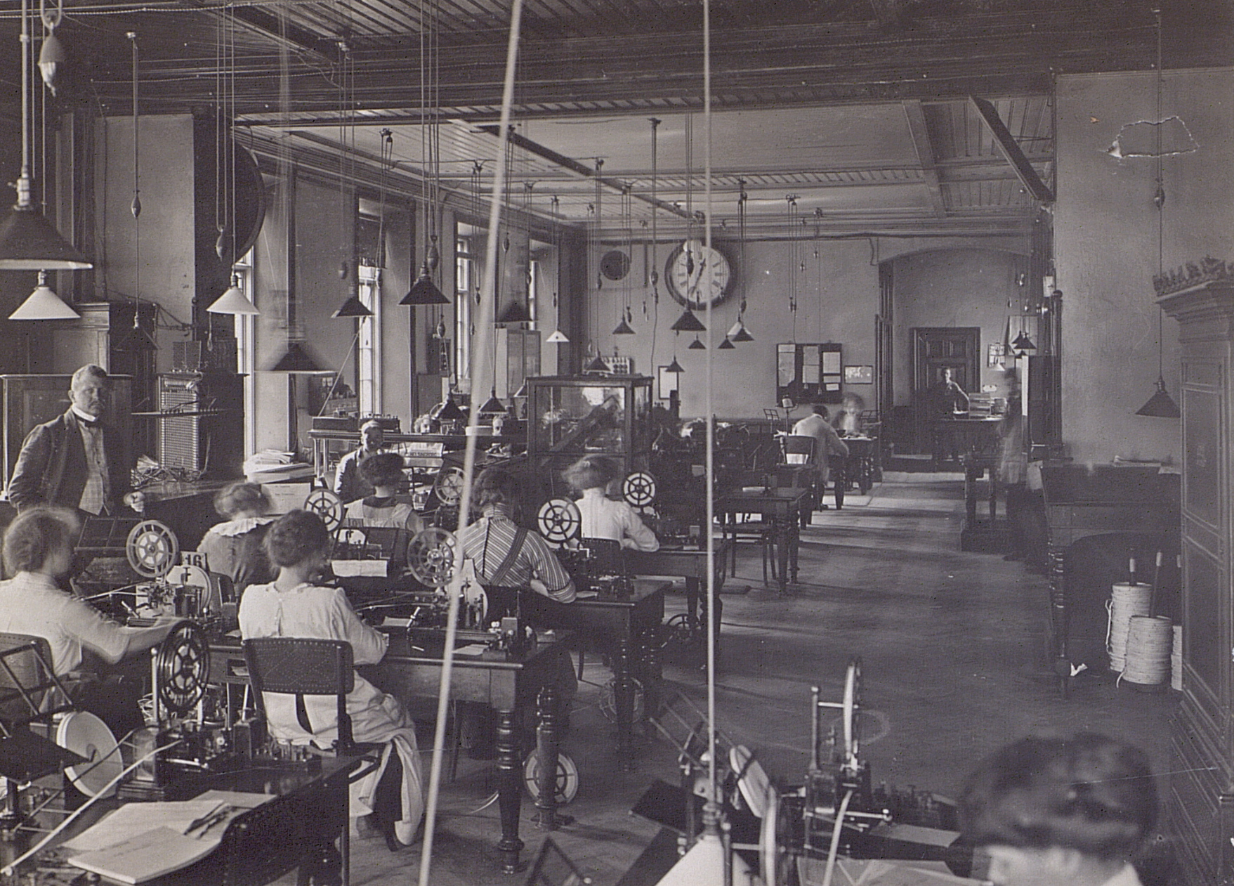 old fashioned sewing machine shop with s sitting at tables