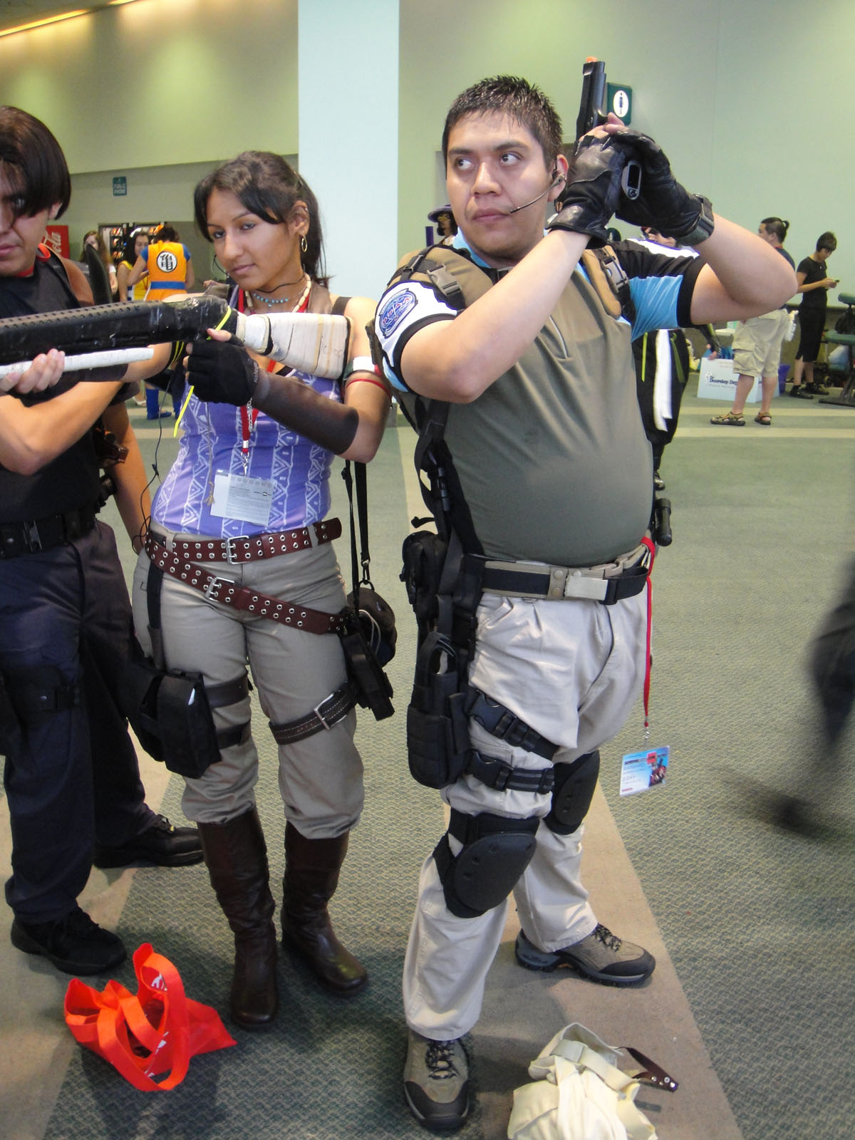 two people in cosplay taking pictures with cell phones