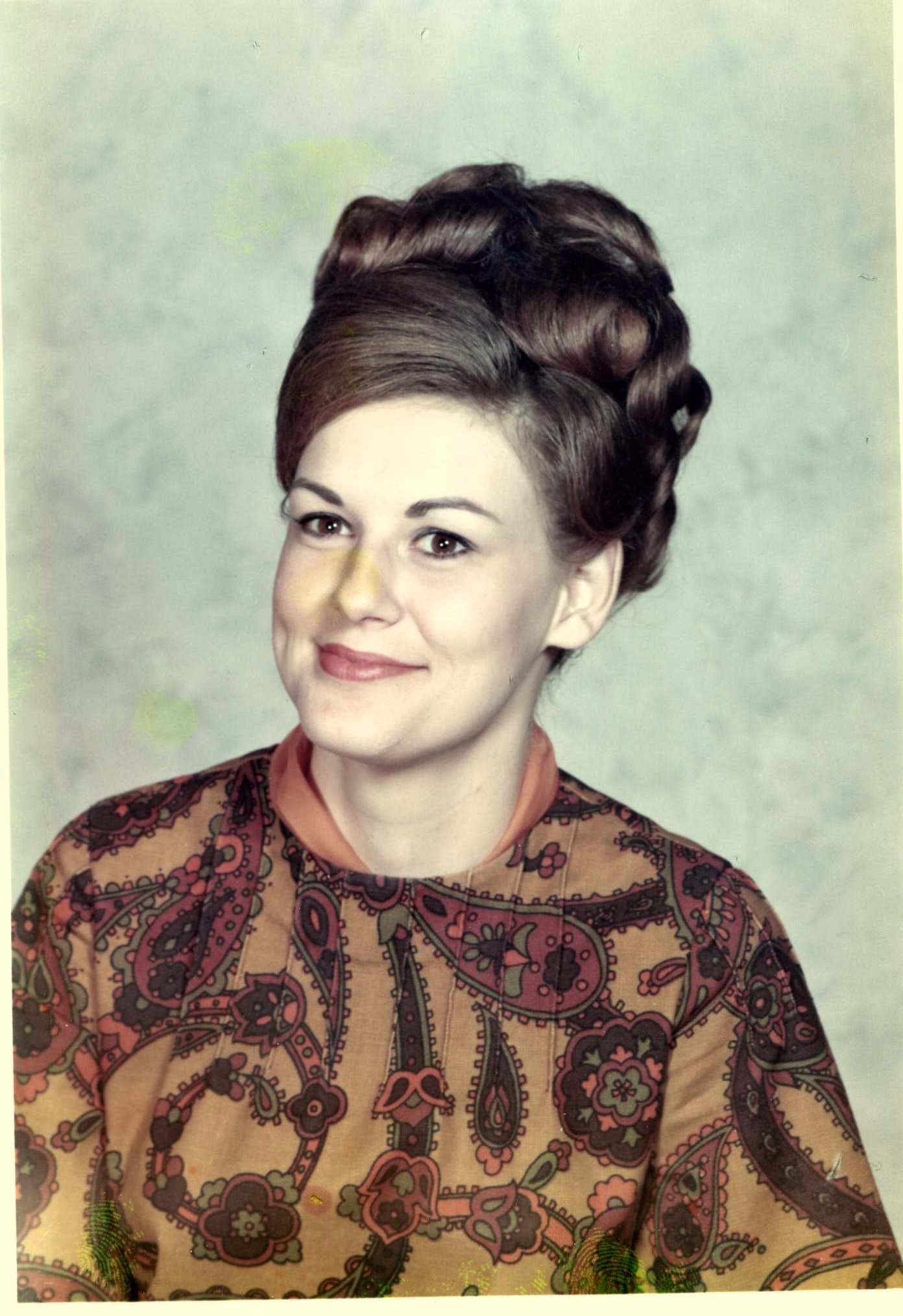 woman with black hair in bun with ornate design