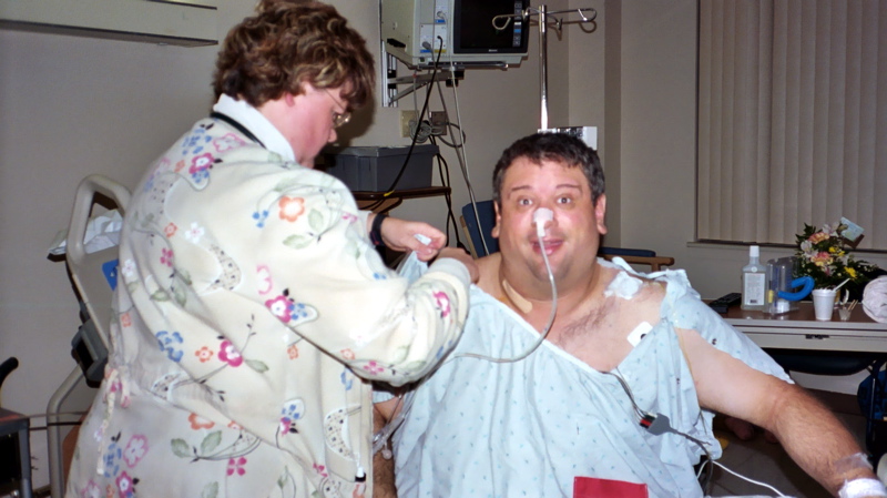 a man is getting his hair brushed by a female