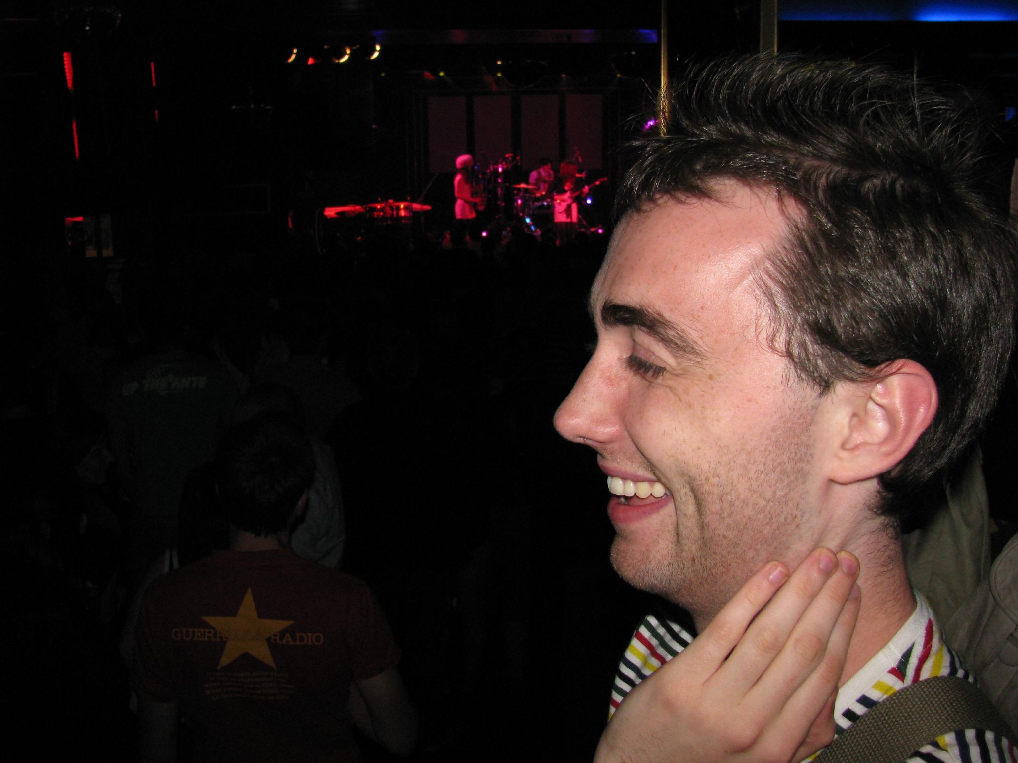 a person at a music concert that is smiling and laughing