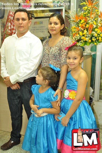 a man and two little girls dressed in dresses standing next to a man