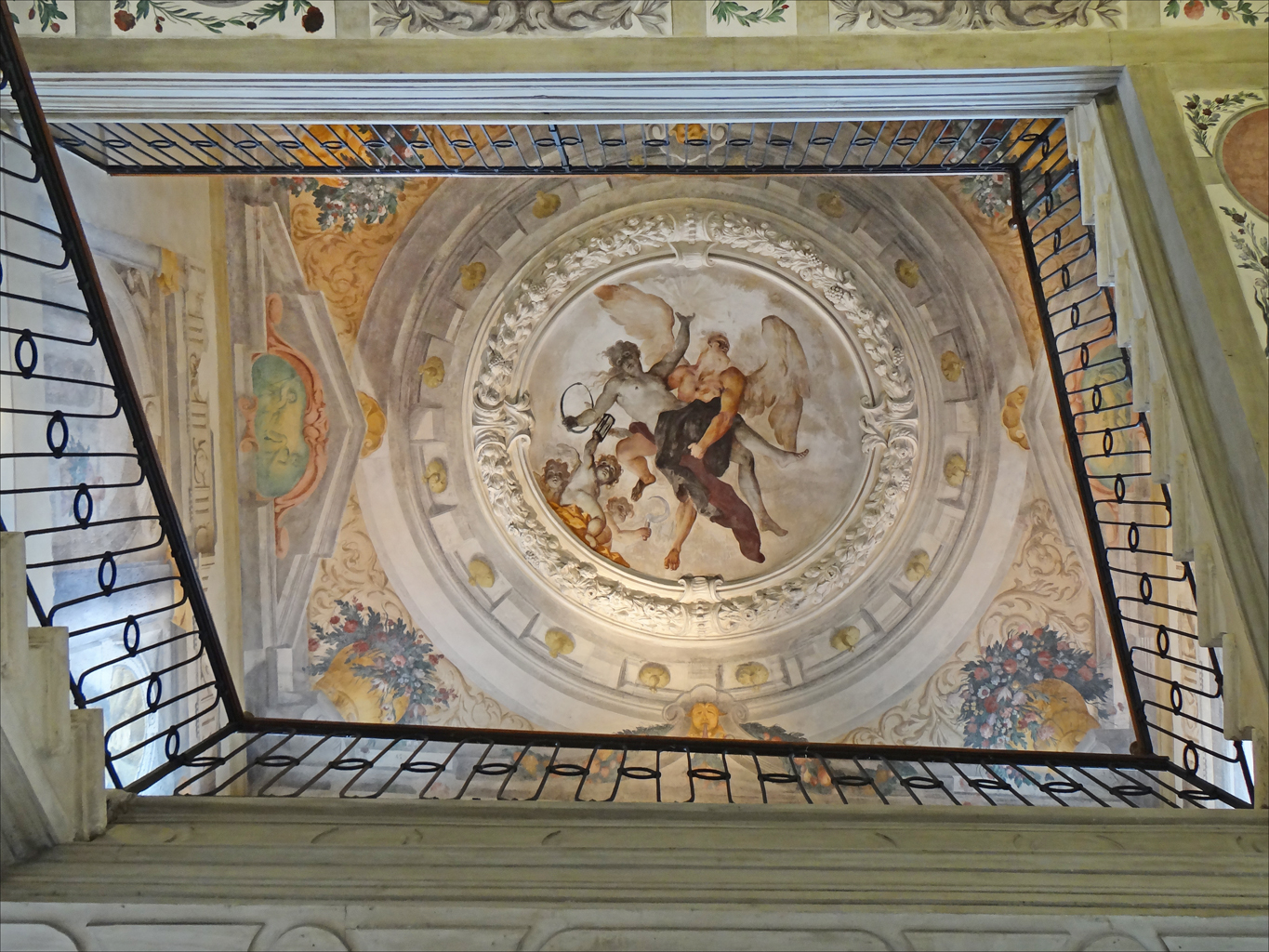 a ceiling in the middle of a church with many paintings on it