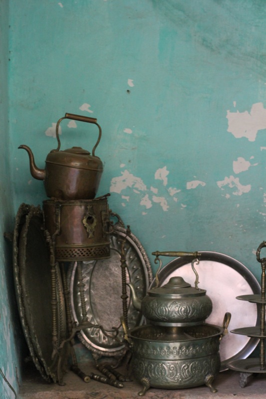 old pots and pans are stacked up against the wall