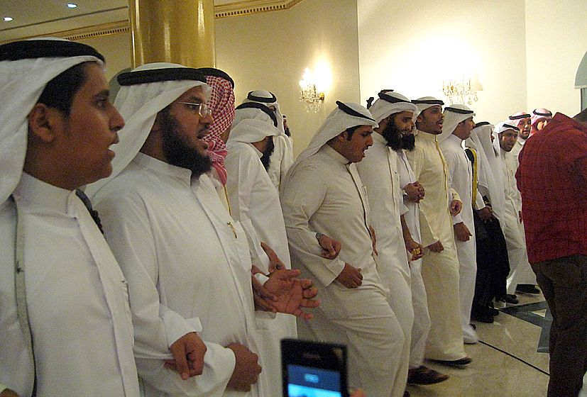 many men dressed in white are standing together