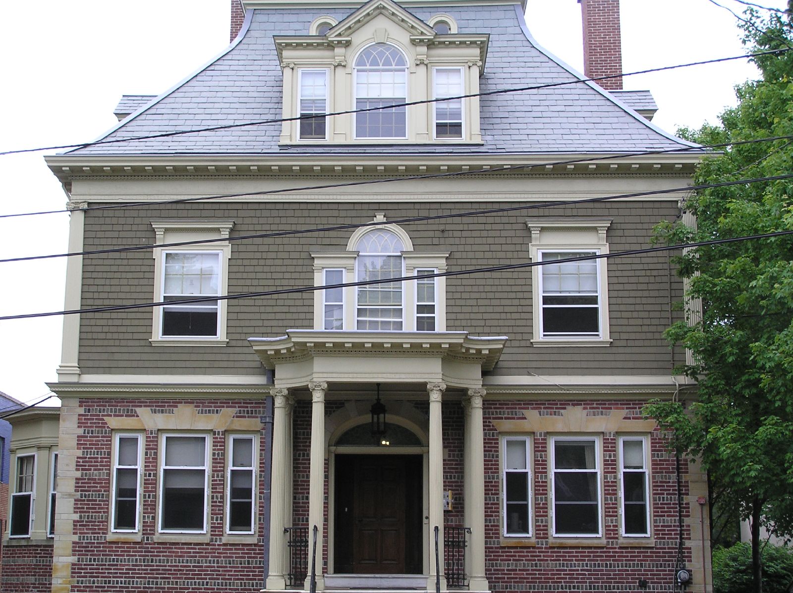 the front of a house, with the second story painted a muted brown