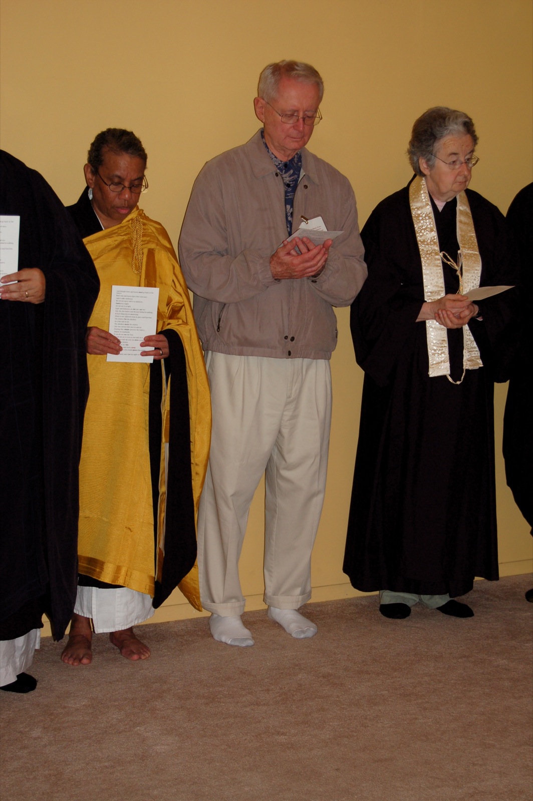 a priest is standing with his arm folded in a prayer