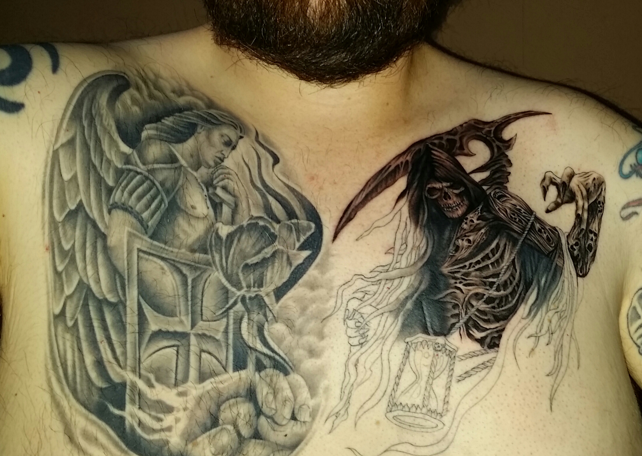 tattoos on a man with two faces and a dragon