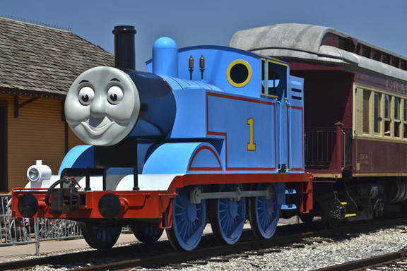 a blue train with a face drawn on the front